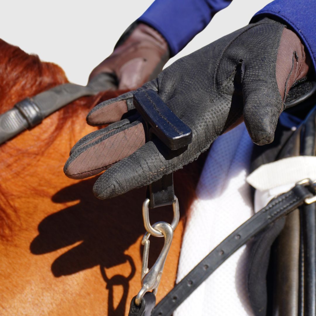 Close up image of the 3-in-1 Training Breastplate in rider's hand